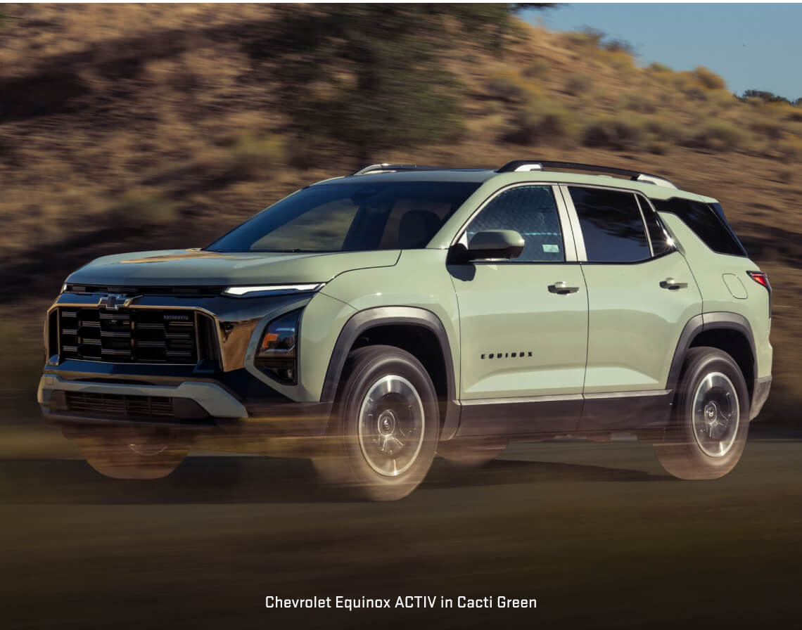 Chevrolet Equinox ACTIV drives fast along a dirt road in a sunny desert setting.