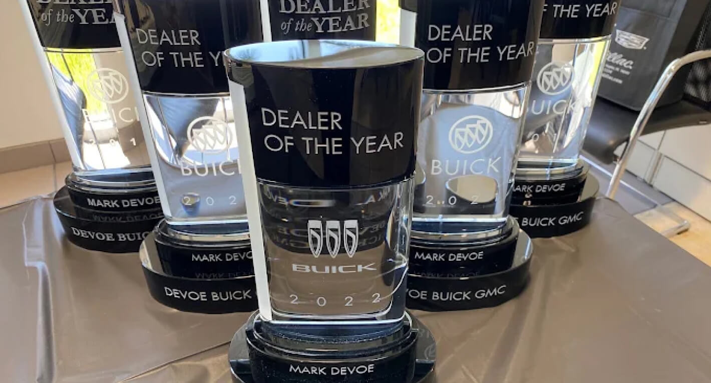 A close-up shot of Devoe Buick GMC's Dealership of the Year Awards lined up on a table.